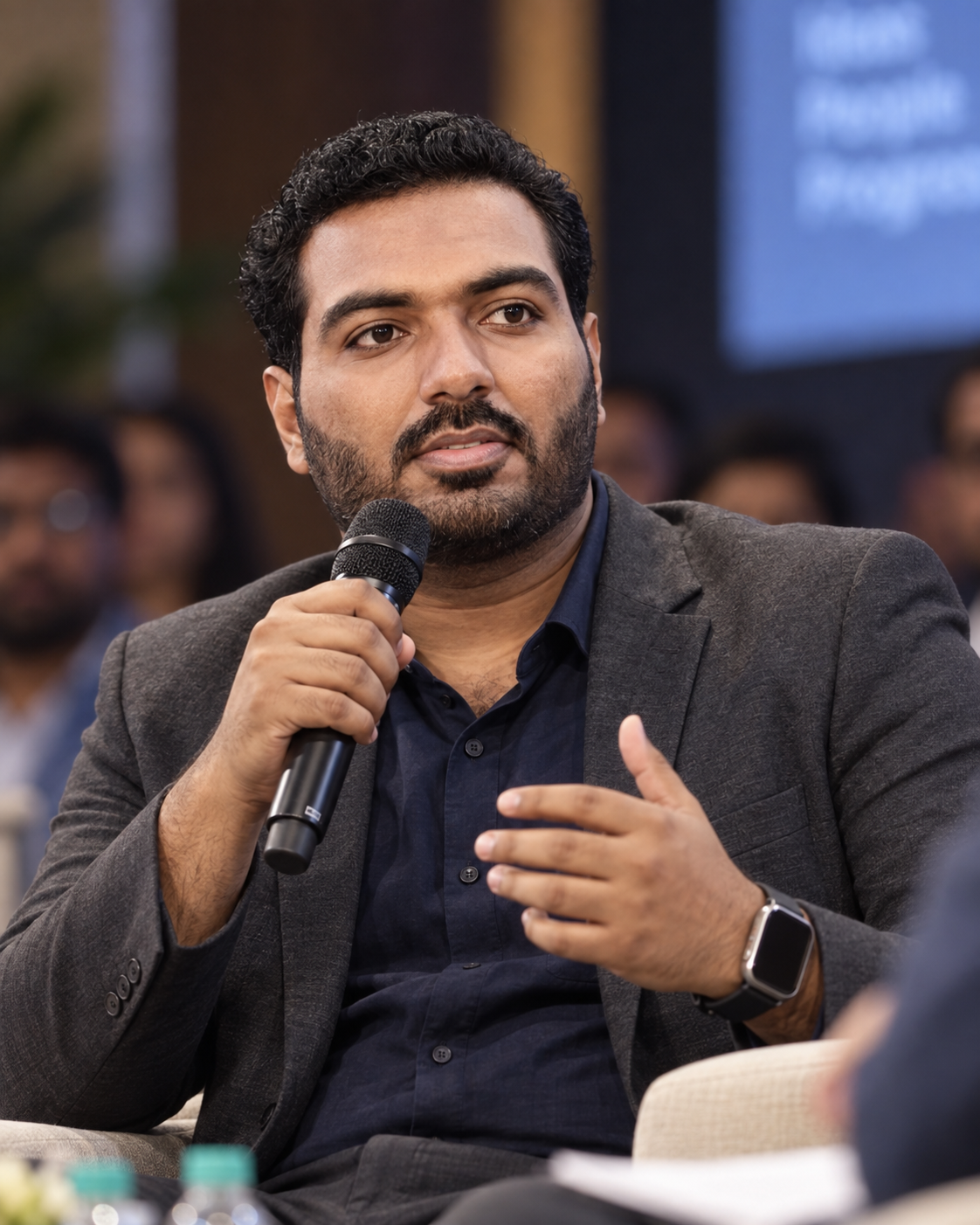 Umair holding a microphone during a discussion